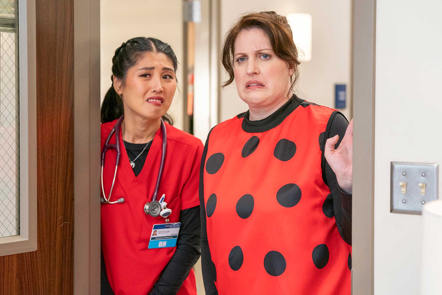 Serena and Alex looking concerned while standing in a doorway in St. Denis Medical Season 1, Episode 14.