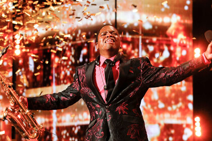 Avery Dixon receiving the Golden Buzzer on the AGT stage