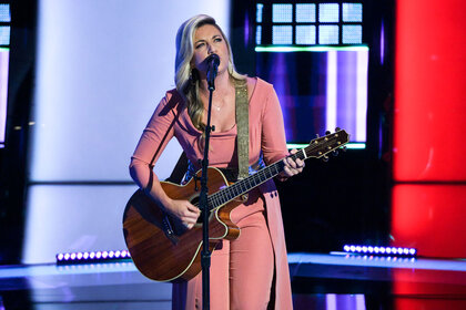 Singer performing on The Voice stage