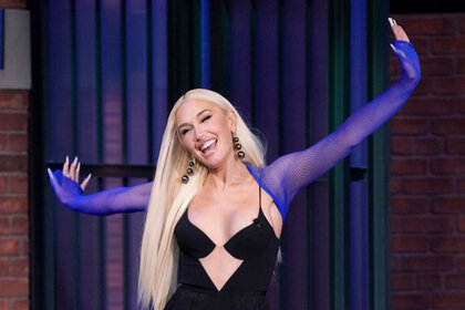 Gwen Stefani smiling with her arms outstretched