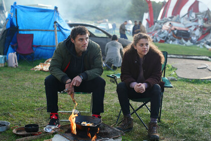 Lucas and Veronica sitting in front of a fire