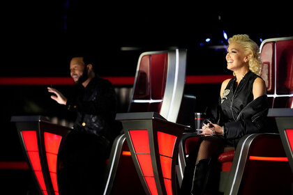 Gwen Stefani and John Legend seated in their chairs