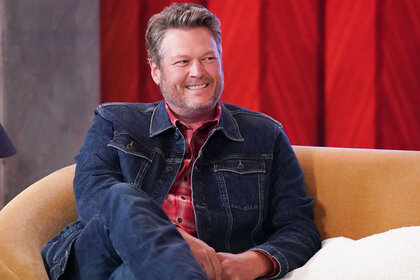 Blake Shelton sitting and smiling