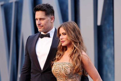 Joe Manganiello And Sofia Vergara posing on the Vanity Fair Oscar Party red carpet.