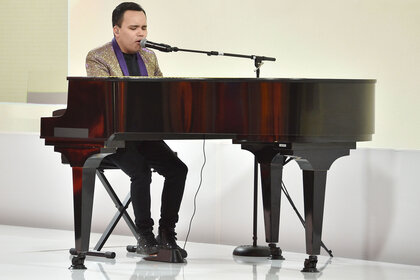 Kodi Lee performing while playing piano