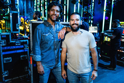 Dan Smyers and Shay Mooney smiling and posing backstage during night 1 of the 50th CMA Fest