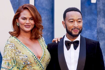 Chrissy Teigen and John Legend posing on the red carpet.