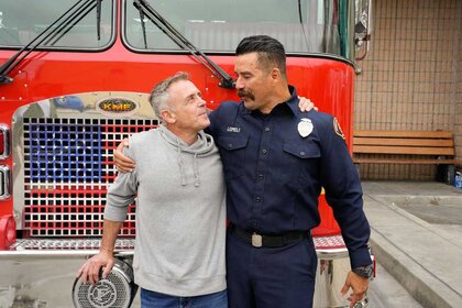 David Eigenberg and Paco Lomeli sharing a hug.