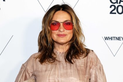 Mariska Hargitay wearing red glasses at an event.