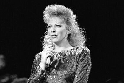 Reba McEntire performing on stage.