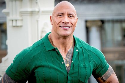 Dwayne Johnson appears at an event wearing a green shirt.