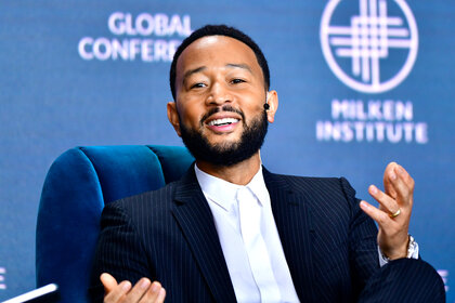 John Legend speaking at an event.