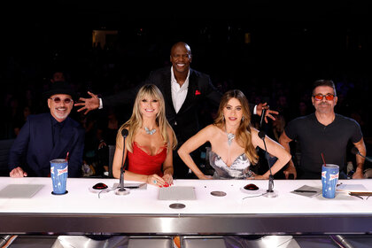 Howie Mandel, Hedi Klum, Terry Crews, Sofia Vergara, and Simon Cowell smile behind the judges's table during the America's Got Talent Season 18 finale