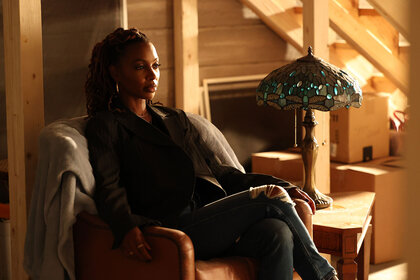 Gabi Mosely (Shanola Hampton) seated in a dimly lit room