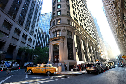 The outside view of the building and an old taxi cab at The Continental The Hotel Bar Experience