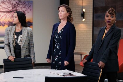 Lacey Quinn, Margaret Reed , and Gabi Mosely standing around a table looking away from each other.