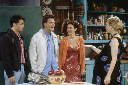 The cast of friends talking to Phoebe on Friends