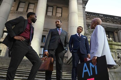 Mason Hill Jones, Alec Mercer, Donald Sales, and Kylie standing around together on the stairs of a building.