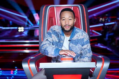 John Legend sits during Season 24, Episode 6 of the Voice