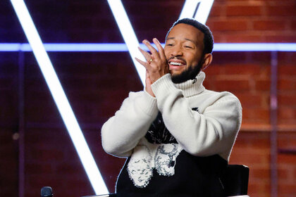 John Legend claps and smiles