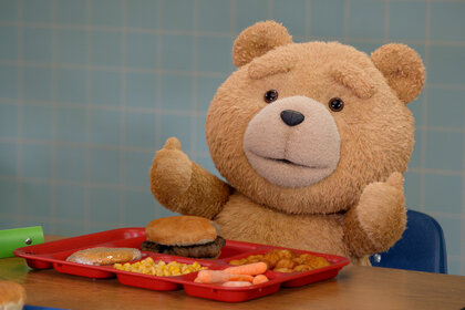 Ted sits at a table with a lunch tray