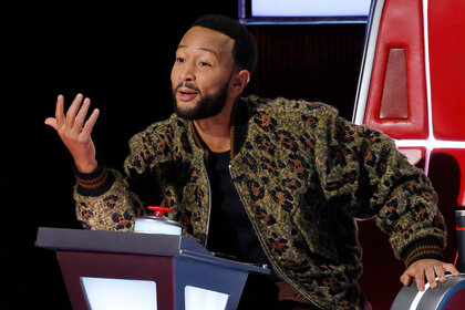 John Legend speaks to a performer