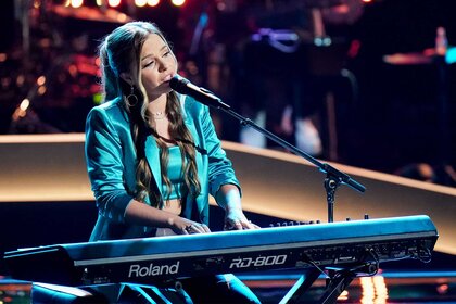 Claudia B. performs on the voice episode 2415