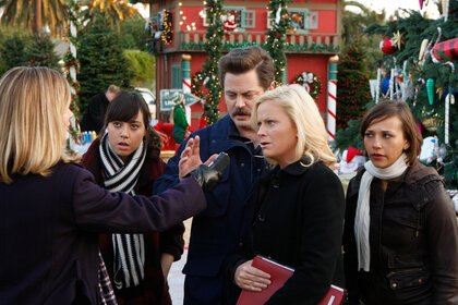 Aubrey Plaza (April Ludgate), Nick Offerman (Ron Swanson), Amy Poehler (Leslie Knope), and Rashida Jones (Ann Perkins) speak to a reporter