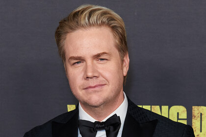 Josh McDermitt wears a tuxedo on the red carpet for he Walking Dead Live: The Finale Event