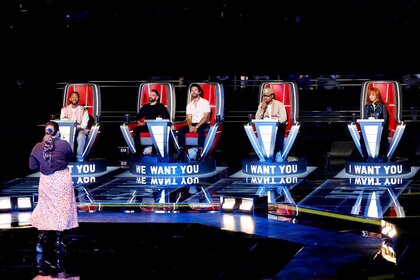 The coaches sit in big red chairs in Season 25 Episode 4 of The Voice.