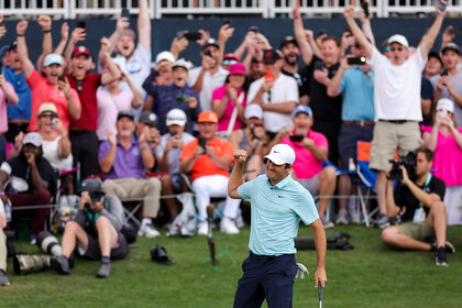 Scottie Scheffler pumps his fist in the air on the 18th green during the final round of THE PLAYERS Championship