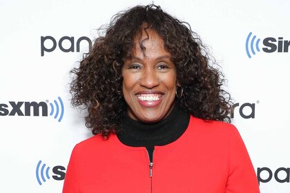 Jackie Joyner-Kerse smiles in a red jacket.