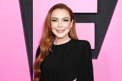 Lindsay Lohan wears a black dress and smiles on the red carpet for the premiere of mean girls