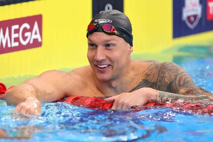 Caeleb Dressel smiles in the pool.