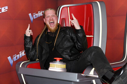 Huntley sits in a coaches chair at an event