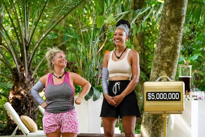 Amy McCoy and Stephanie Mitchell stand near a golden $5 million briefcase on Deal or No Deal Island Episode 107,