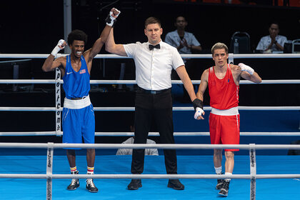 Roscoe Hill (Blue) of USA celebrates after winning over Gan-Erdene Gankhuyag (Red) of Mongolia