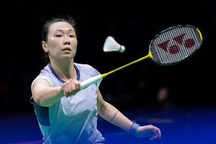 Beiwen Zhang hits the birdie duing a Badminton match