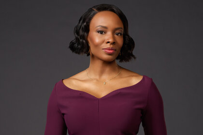 Dr. Carol Pierce wears a dark purple dress for Brilliant Minds Season 1