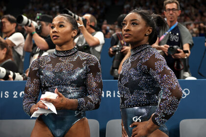 Jordan Chiles and Simone Biles look on from the sidelines during the Artistic Gymnastics Women's Qualification in Paris