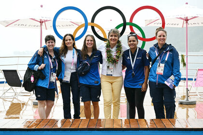 Director of the surfing site for Paris 2024 Olympic and Paralympic Organising Committee poses on the ship with the crew