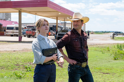 Kate holds an i-pad as Tyler looks at her and smiles in Twisters