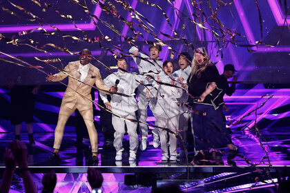 Airfootworks celebrates on stage with Terry Crews after getting a golden buzzer