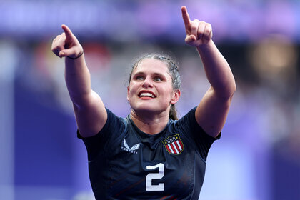 Ilona Maher points up to the crowd during a rugby match at the 2024 olympics