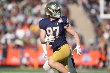 Notre Dame Fighting Irish tight end Cooper Flanagan runs on the field during a football game