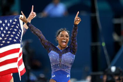 Simone Biles cheers after winning gold at the 2024 olympics