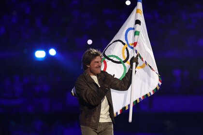 Tom Cruise holds the Olympic flag at the Closing Ceremony in Paris