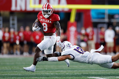 Indiana Hoosiers running back Kaelon Black runs with the ball while pursued by Western Illinois Leathernecks linebacker Ryan Crandall