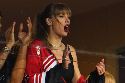 Taylor Swift wears a KC jacket while watching the Kansas City Chiefs play the Denver Broncos