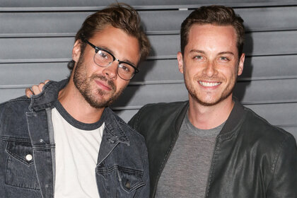 Patrick Flueger and Jesse Lee Soffer pose together on the red carpet